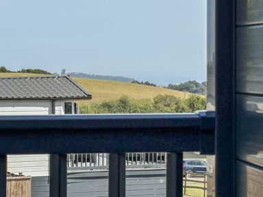 A view of a house and fields from a balcony at Birch Cottage Scarborough