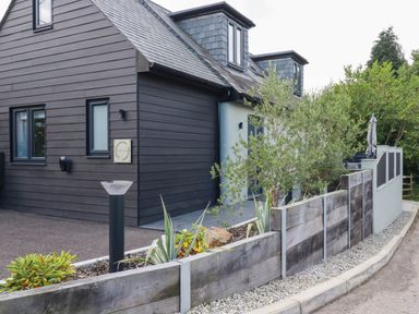A house with a fence and plants at Tiddlywink near Indian Queens