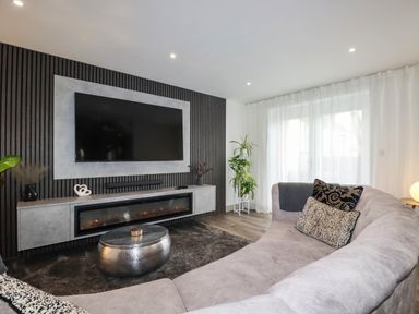 A living room with a television and sofa at Tiddlywink near Indian Queens