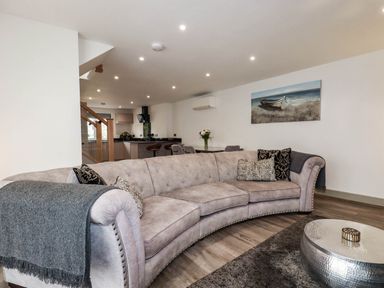 A living room with a sofa and table at Tiddlywink near Indian Queens