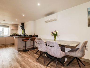 A kitchen with a dining table and chairs at Tiddlywink near Indian Queens