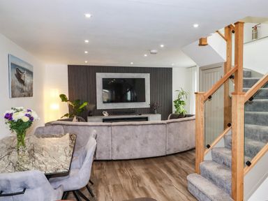 A living room with a sofa and television at Tiddlywink near Indian Queens