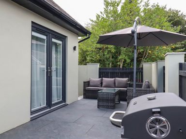 An outdoor area with seating and grill at Tiddlywink near Indian Queens