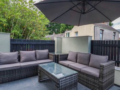 An outdoor seating area with a sofa and table at Tiddlywink near Indian Queens