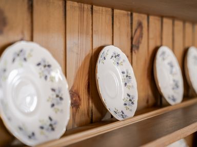 A shelf with decorative plates on display at Cove Cottage in Llangrannog