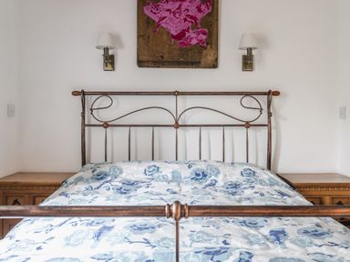 A bedroom with a bed and bedside tables at Y Bwthyn in Llangrannog