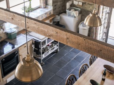 A kitchen with a dining table and chairs at Coach House in Llangrannog
