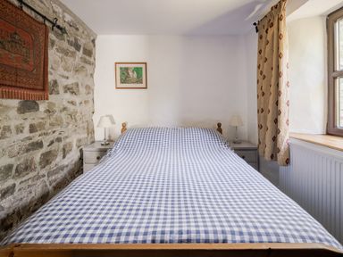 A bedroom with a bed and lamp at Coach House in Llangrannog