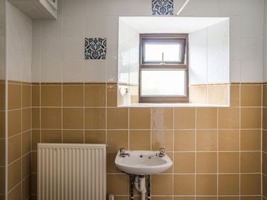 A bathroom with a sink and window at Coach House in Llangrannog
