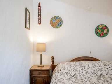A bedroom with a bed and lamp at Coach House in Llangrannog