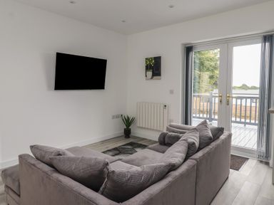 A living room with a sofa and television at Castle View in Scarborough