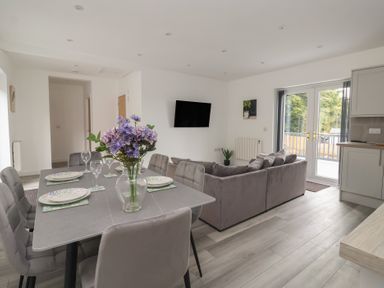 A living room with a dining area and sofa at Castle View in Scarborough