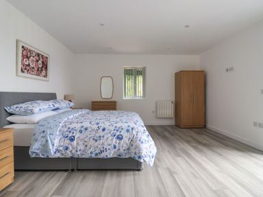A bedroom with a bed and a wardrobe at Castle View in Scarborough