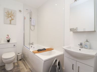 A bathroom with a bathtub and sink at Castle View in Scarborough