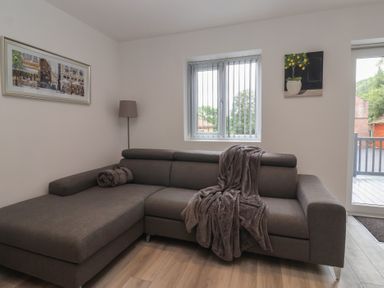 A living room with a sofa and window at Woodside in Scarborough
