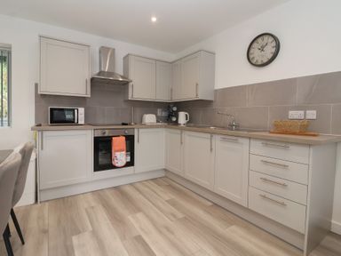 A kitchen with cabinets and appliances at Woodside in Scarborough