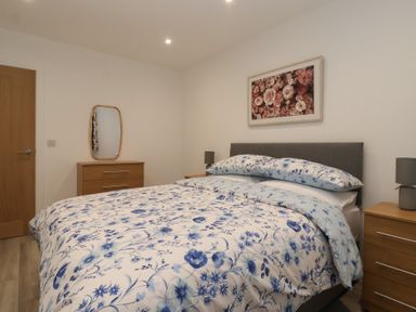 A bedroom with a bed and dresser at Woodside in Scarborough