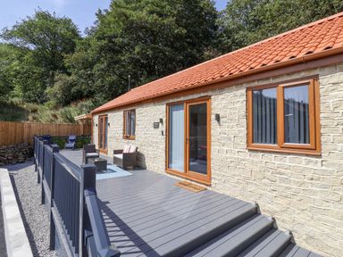 A building with a deck and furniture at Woodside in Scarborough