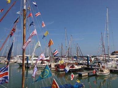 A marina with sailboats decorated with signal flags in the water at Cape A9 Norton Near Freshwater