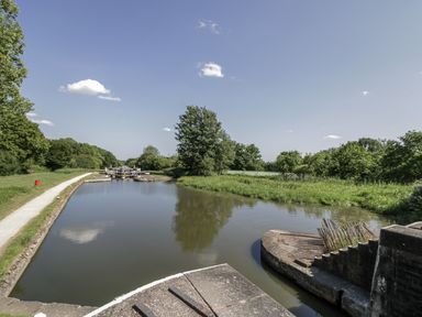 A river with trees and a pathway alongside at The Lodge in 