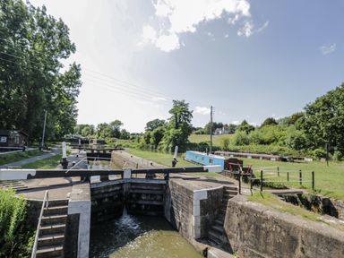 A waterway with lock gates and boats alongside a path at The Lodge in 