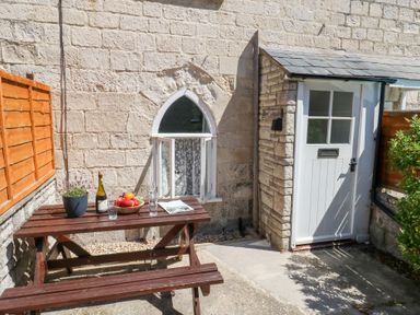 An outdoor area with a table and chairs at Driftwood in Weymouth