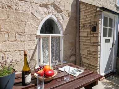 A table with fruit and a bottle outside Driftwood in Weymouth