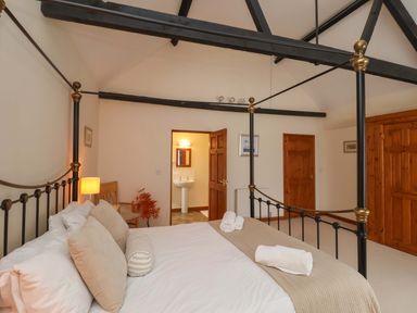 A bedroom with a bed and sink at Beechwood in Wood Norton
