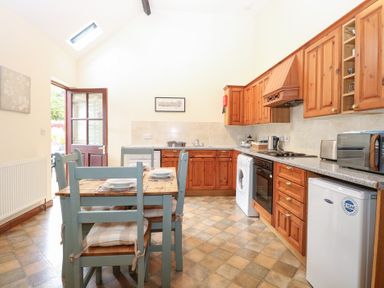 A kitchen with wooden cabinets and appliances at Willow in Wood Norton near Foulsham