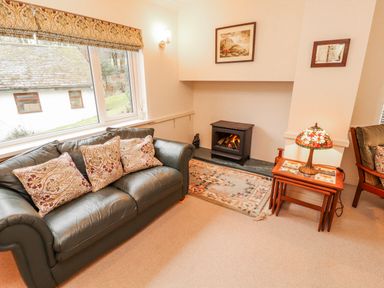 A living room with a sofa and fireplace at High Cross in Keswick