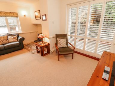 A living room with a sofa and armchair at High Cross in Keswick