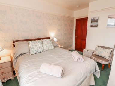 A bedroom with a bed and nightstand at High Cross in Keswick