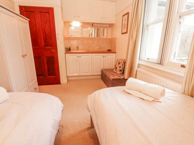 A bedroom with twin beds and a sink at High Cross in Keswick