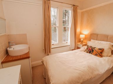 A bedroom with a bed and a sink at High Cross in Keswick