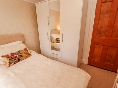 A bedroom featuring a bed and wardrobe at High Cross in Keswick