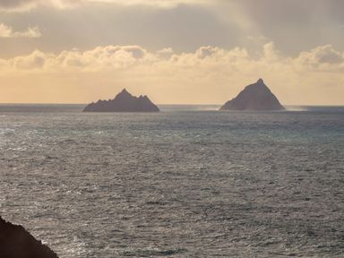 Two islands in the ocean under a cloudy sky at O'Conells Portmagee