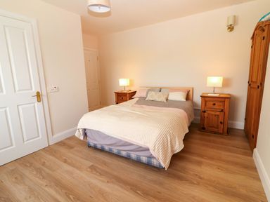 A bedroom with a bed and bedside tables at O'Connell's Lodge, Portmagee, County Kerry