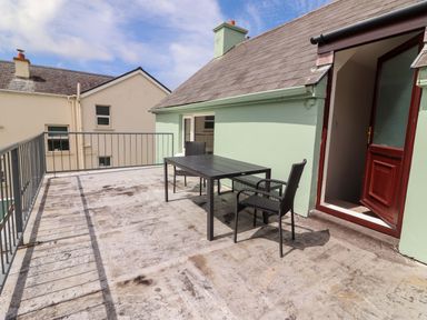 An outdoor terrace with a table and chairs at O'Connell's Lodge, Portmagee, County Kerry