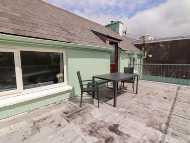 An outdoor area with a table and chairs at O'Connell's Lodge, Portmagee, County Kerry