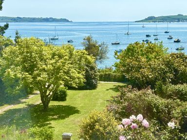 A garden with a view of water and boats at Nanvivian Feock near Truro