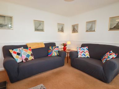 A living room with sofas and a lamp at Nanvivian in Feock near Truro