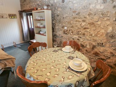 A dining room with a table set at 8 Rogeston Cottages Haverfordwest