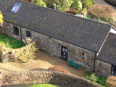 A building with a door and windows surrounded by a garden at 8 Rogeston Cottages Haverfordwest