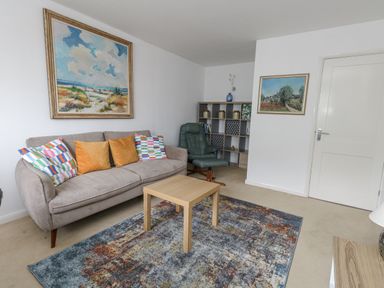A living room with a sofa and coffee table at Flat 13, Chesil House in Bridport