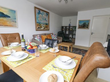 A dining area with a table set and furniture at Flat 13, Chesil House in Bridport