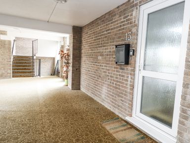 An entrance with a door and mailbox at Beachcombers, 13 Chesil House in Bridport