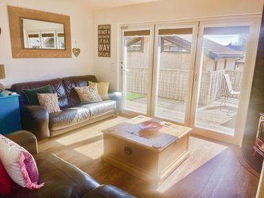 A living room with a sofa and coffee table at Woodburn Lodge in Otterburn