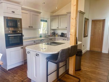 A kitchen with appliances and countertops at Woodburn Lodge Otterburn
