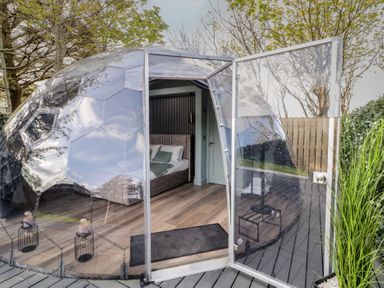 A transparent dome with an open door showing a bedroom inside at Number 1 Dome in Derrybeg County Donegal