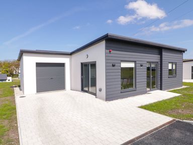 A modern single-story house with a garage and paved driveway at Number 2 Villa - The View in Derrybeg County Donegal